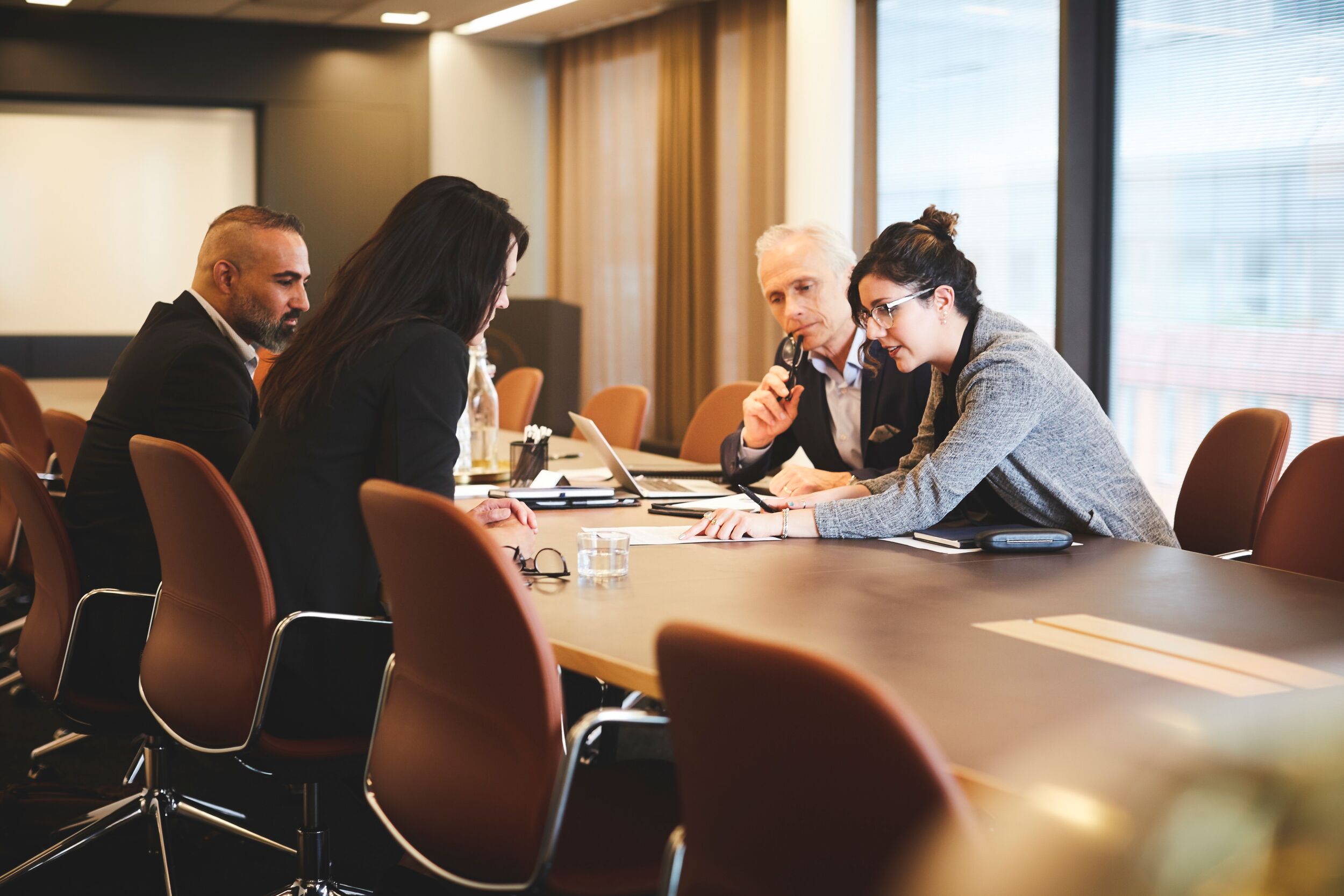 Coworkers meeting in a board room.